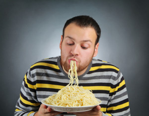 bigstock-funny-young-man-eating-pasta-38925736